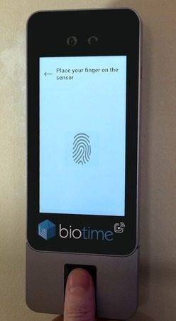 An employee placing their finger on the bt505's fingerprint sensor. An employee placing their finger on the bt505's fingerprint sensor.